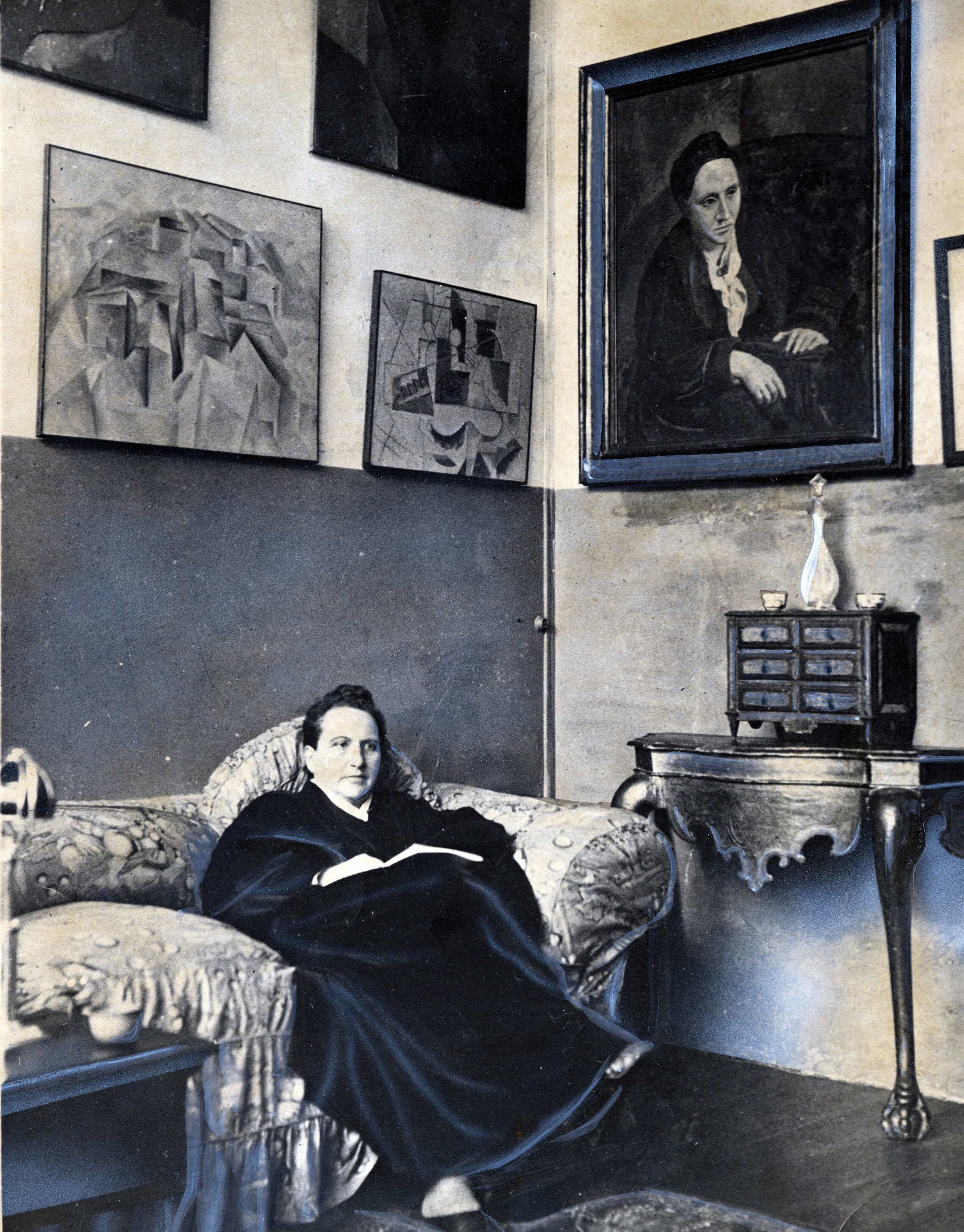 A photograph of a woman reclining on a couch.