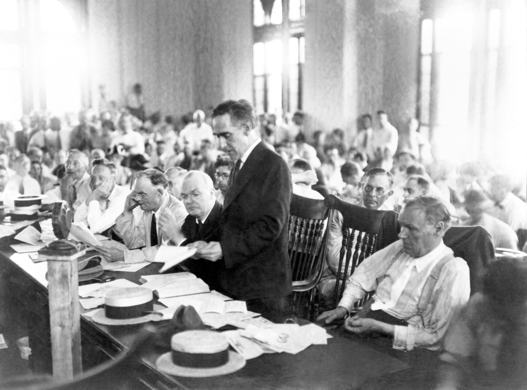 A black-and-white photograph of a courtroom filled with people.
