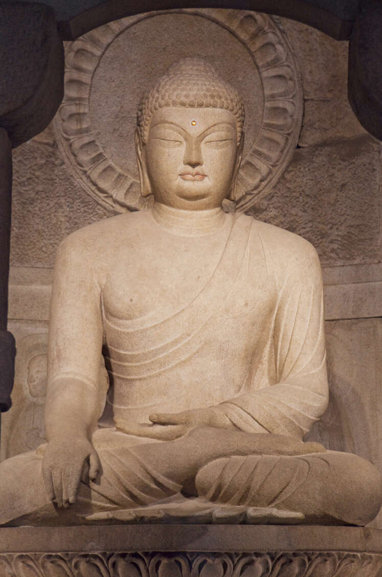 Granite Buddha statue, seated.