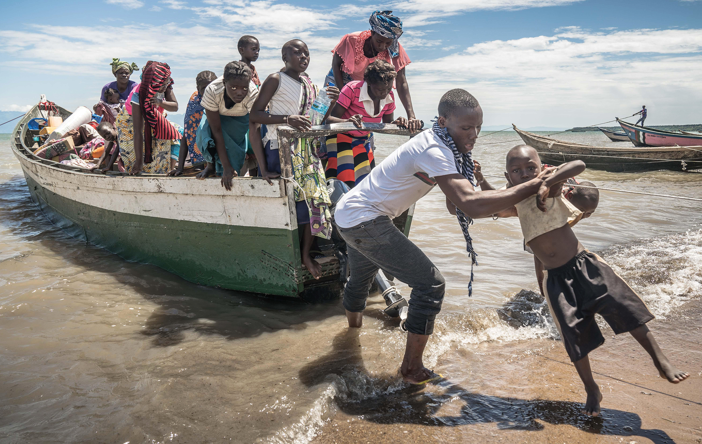 A small boat filled with Congalese refugees are waiting to get off the boat.