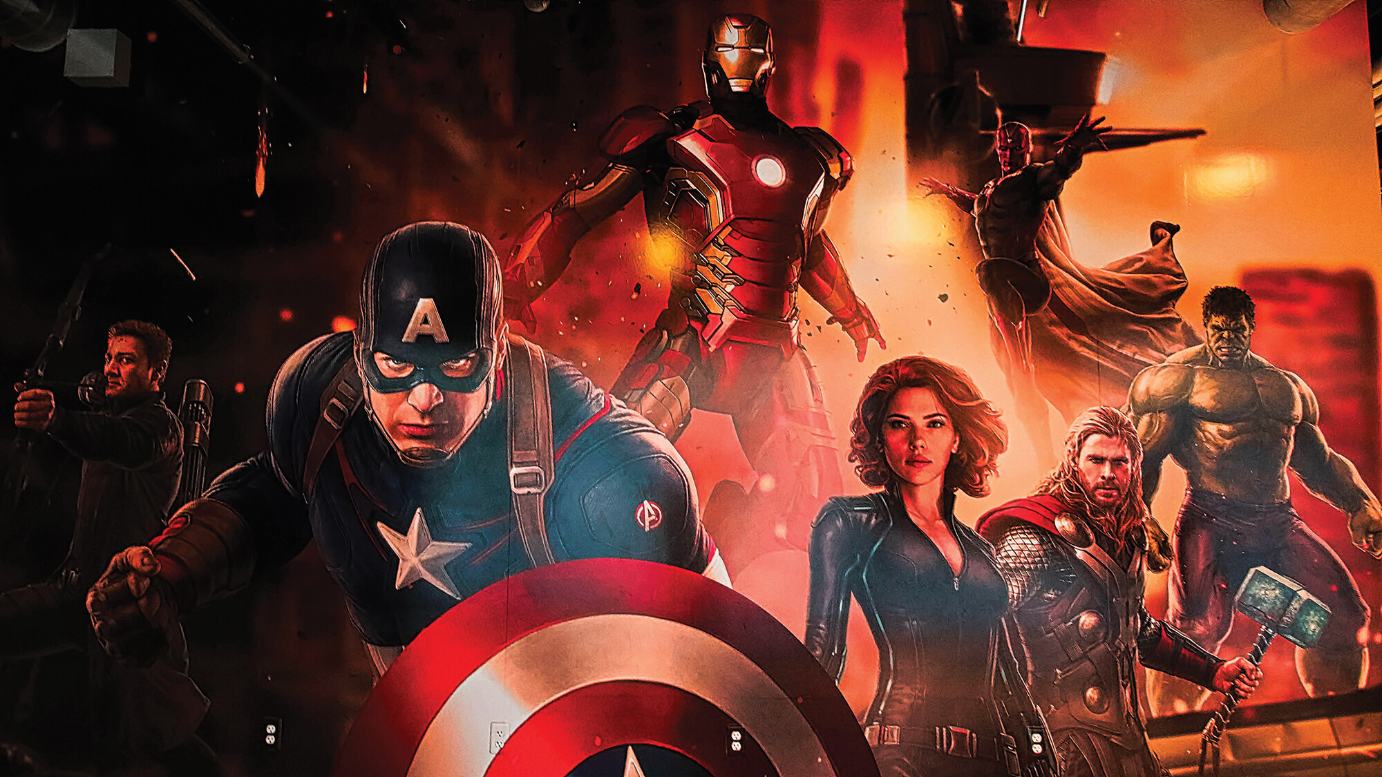 A collage of superhero characters from the Marvel Cinematic Universe. Among them are Captain America, Black Widow, Iron Man, Thor, The Hulk, and Hawkeye.