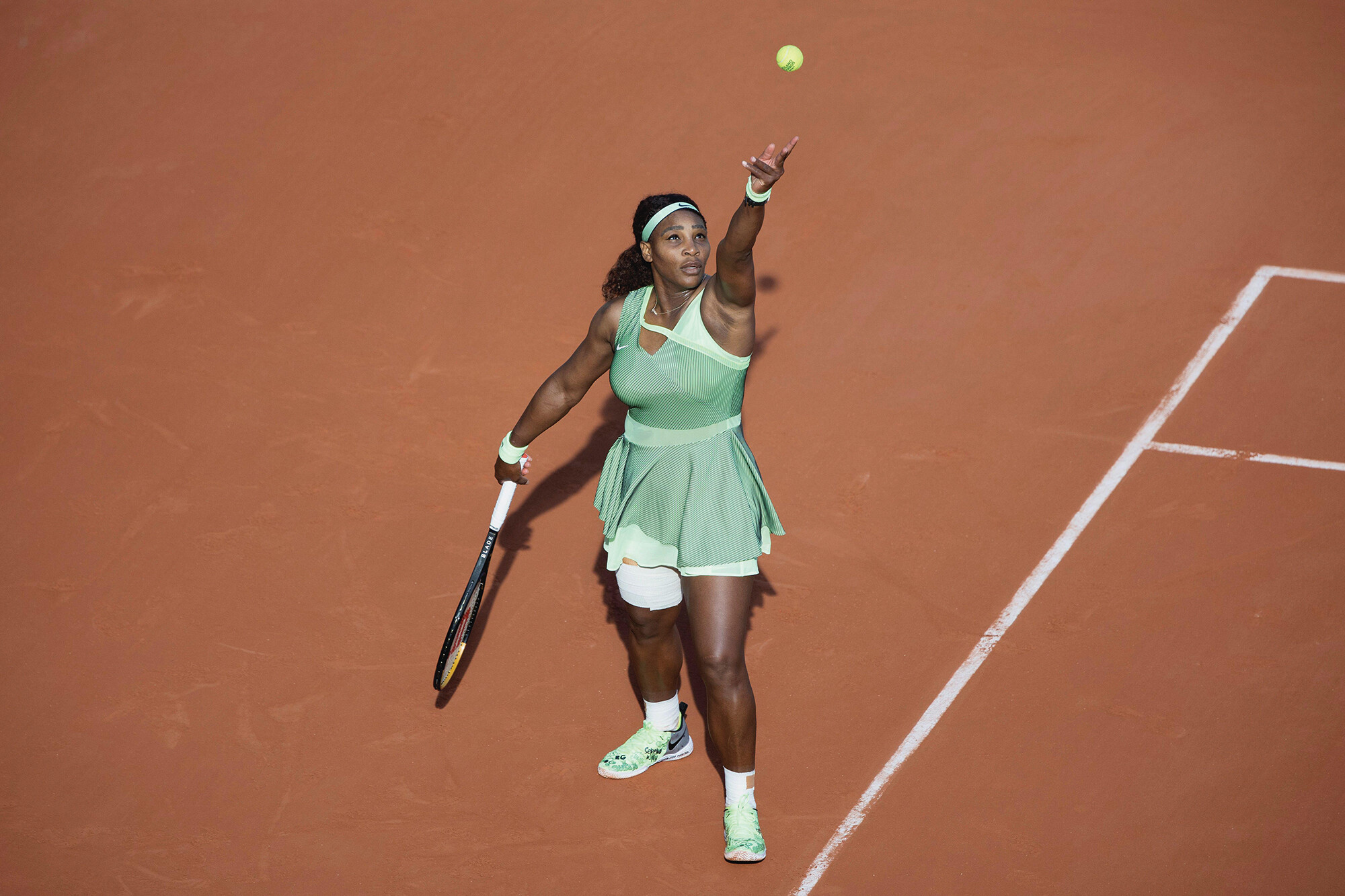 Serena Williams mid-serve.