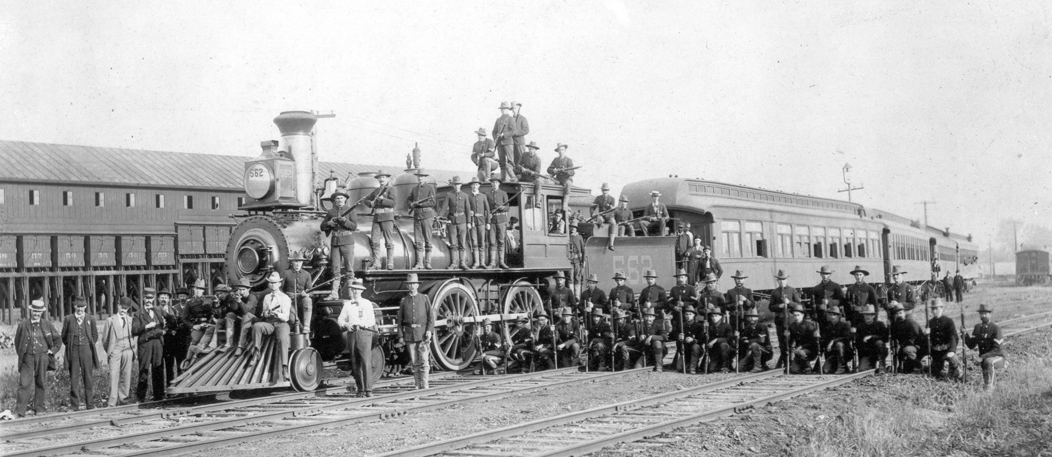Federal troops pose atop a railroad engine after Pullman strike, 1894