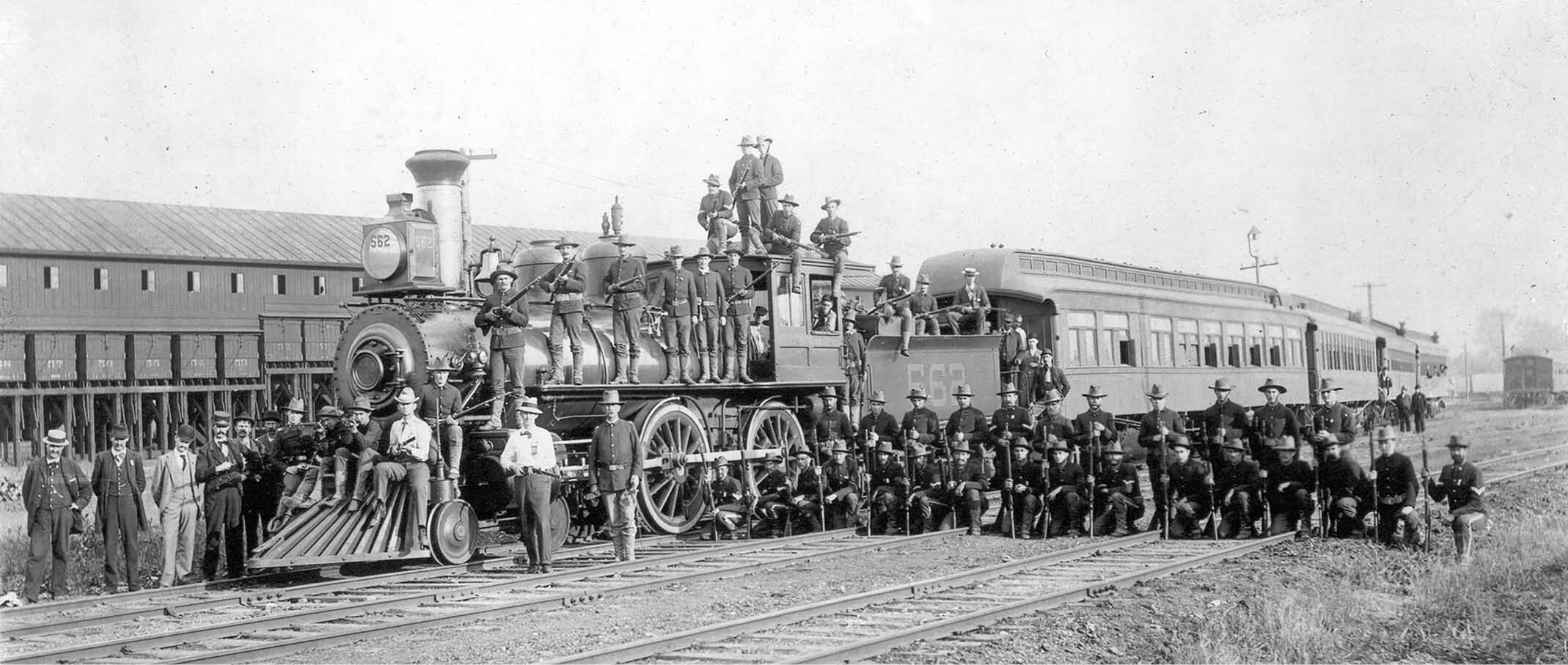 Federal troops pose atop a railroad engine after Pullman strike, 1894