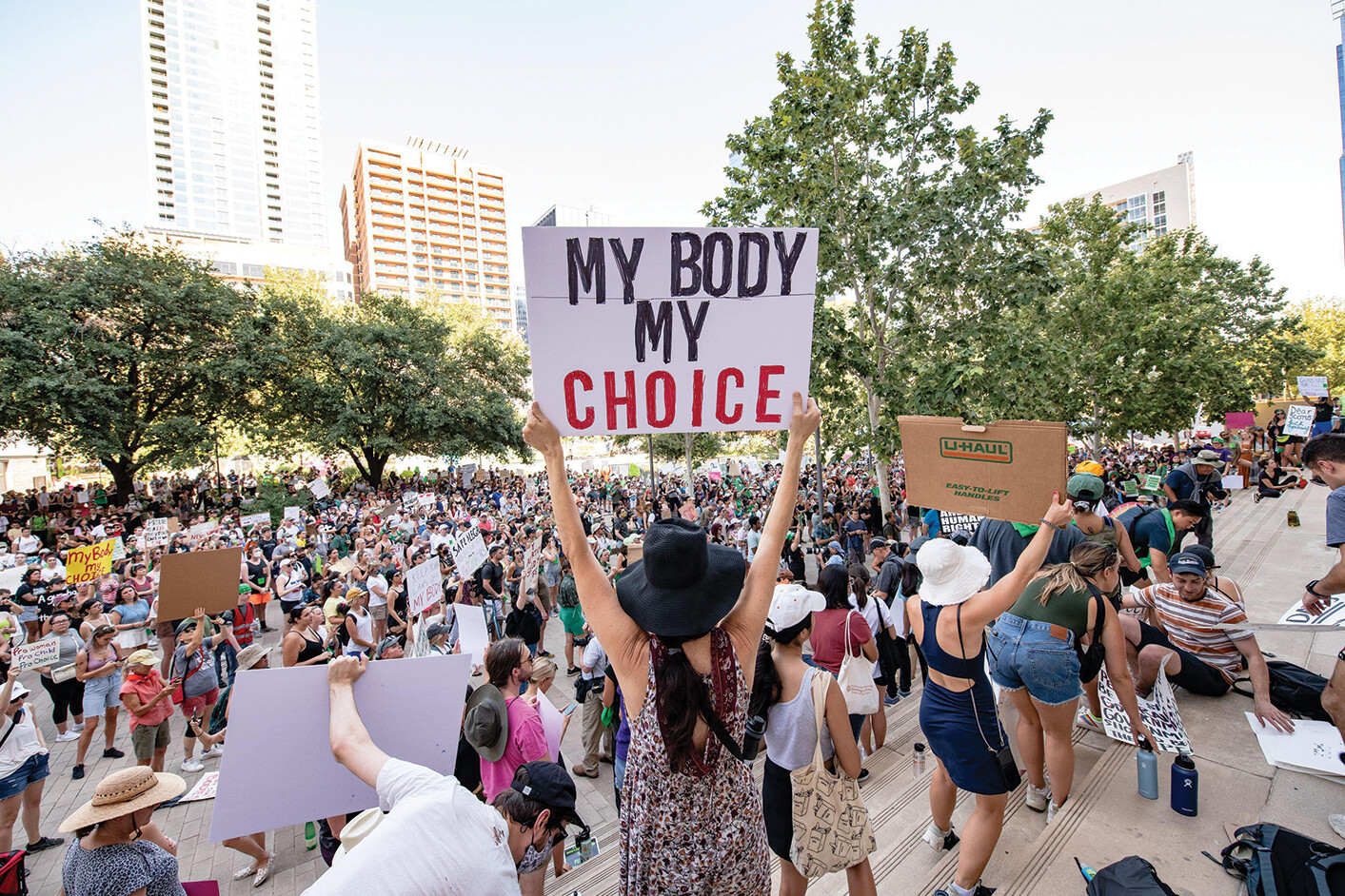 A group of demonstrators hold signs reading Keep Families Together and Families Belong Together.