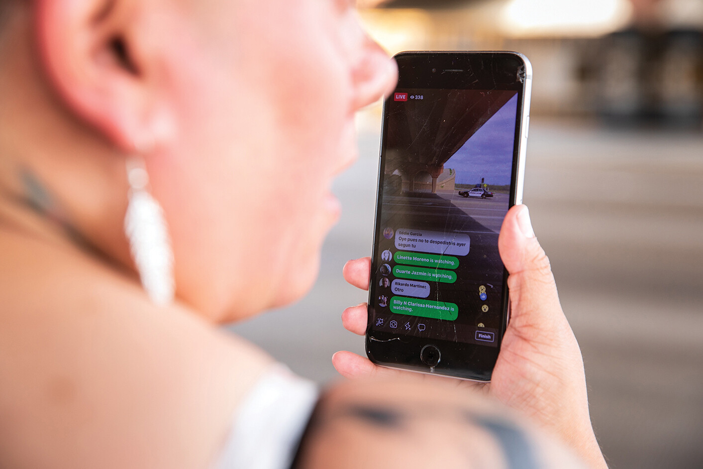 A photo shows a close-up of a citizen journalist, Priscilla Villarreal, documenting real time events on her phone.