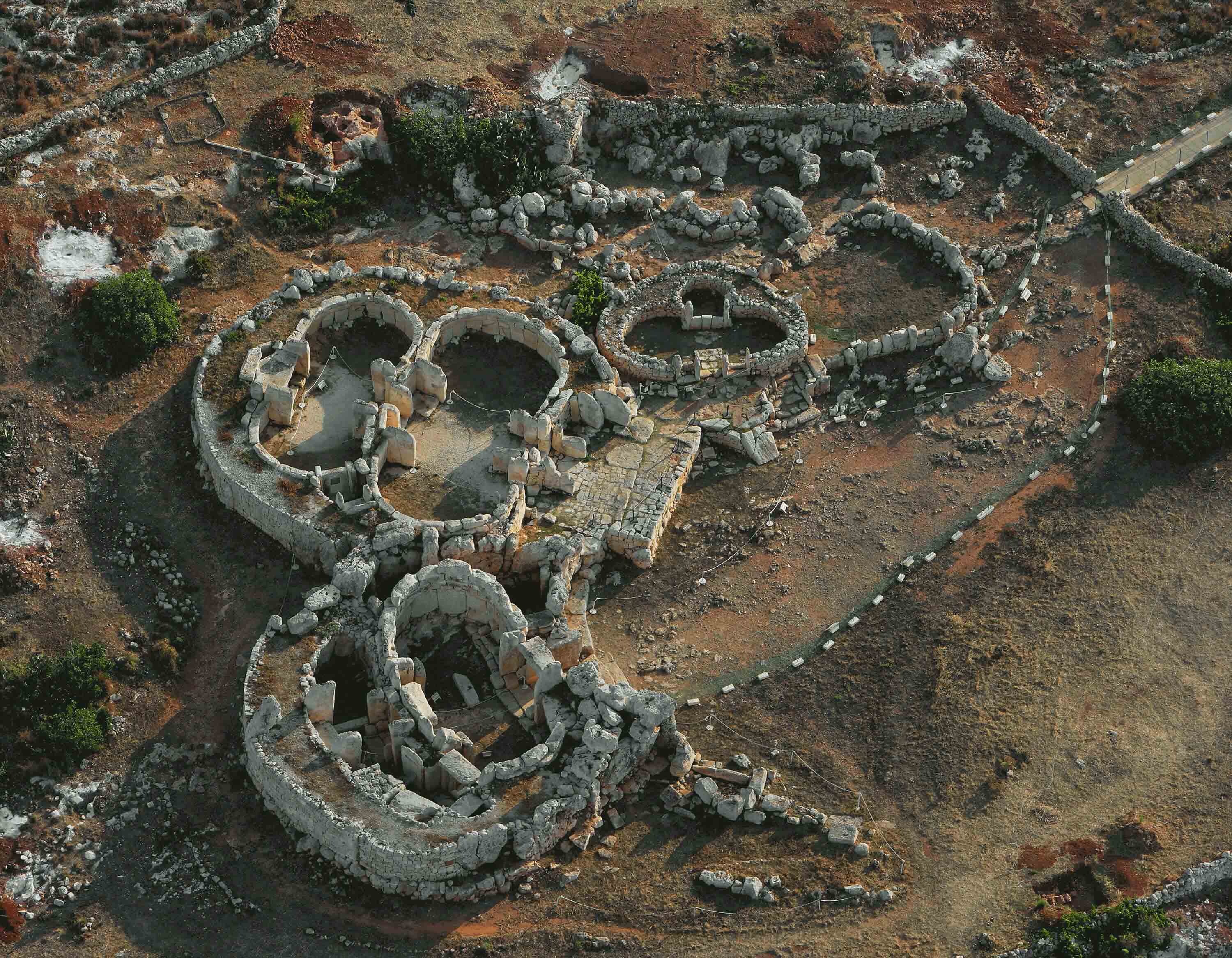Excavated complex of rounded stone structures.
