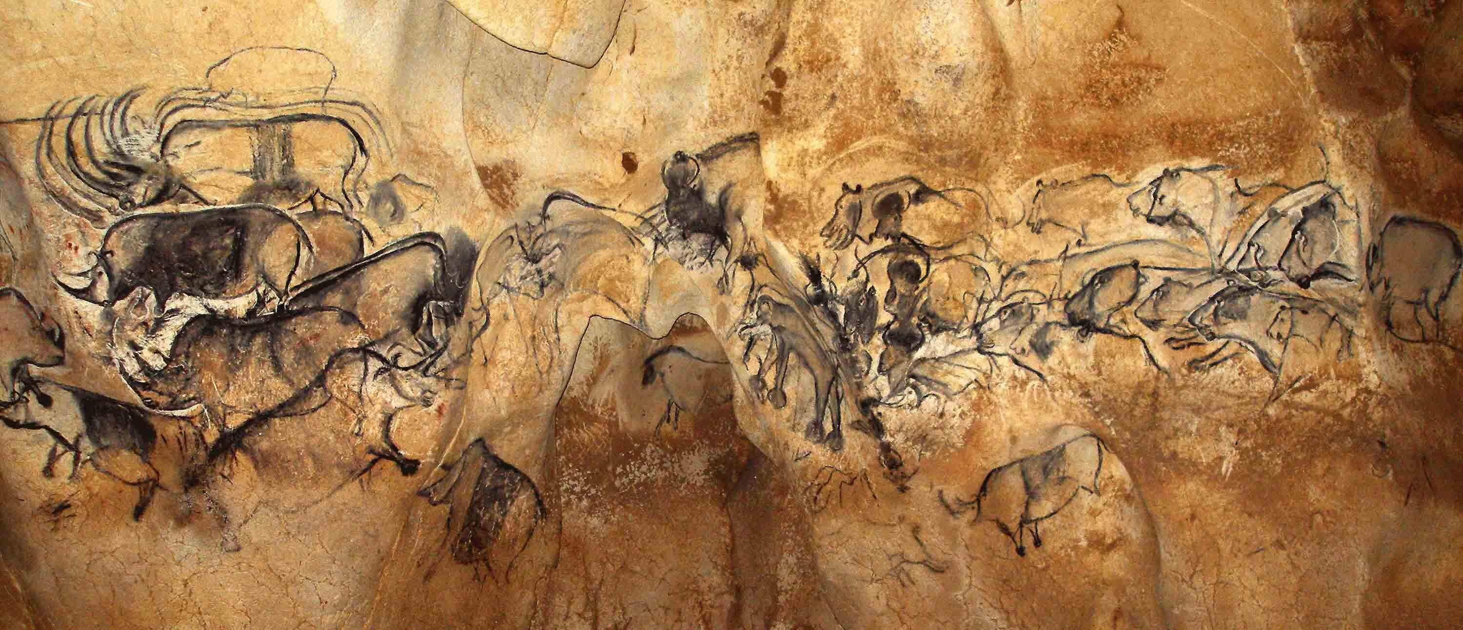 Wall mural in charcoal, depicting a mass of moving animals.