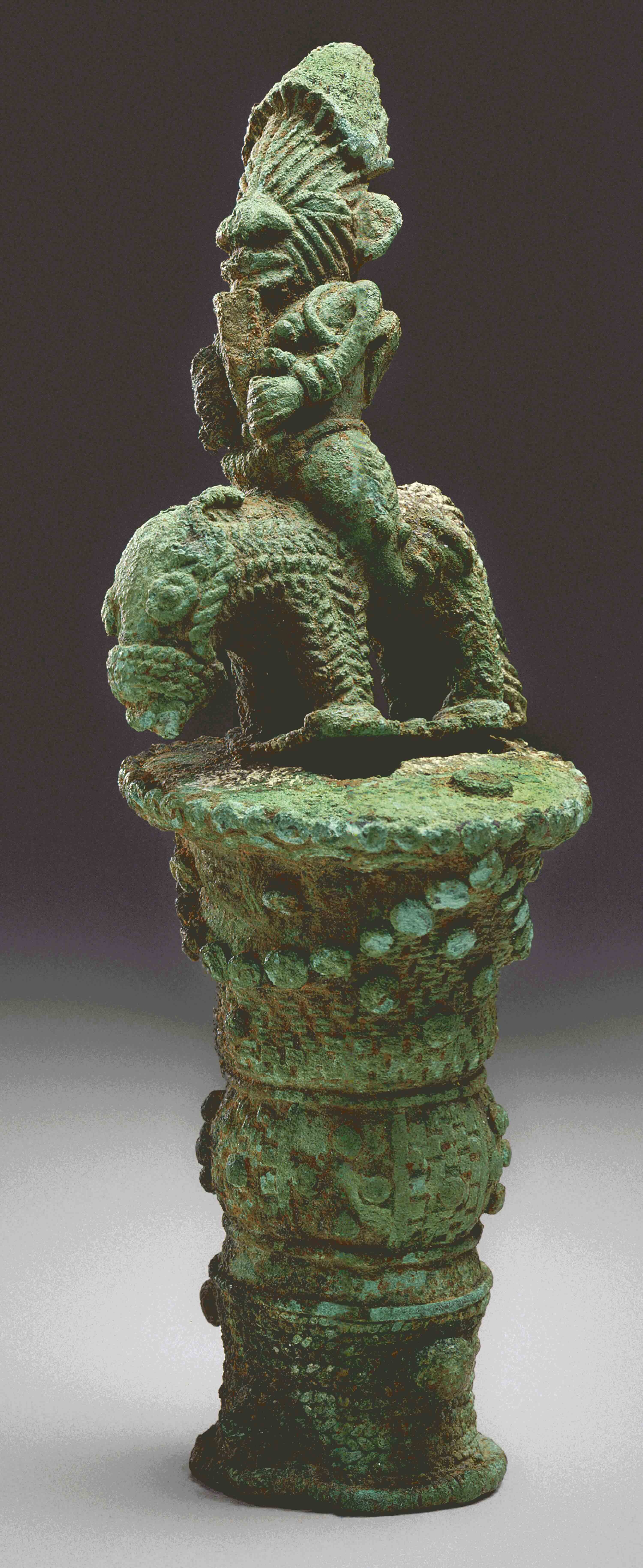 Endcap to a flywhisk or staff, with blue-green patina, topped with a horse and rider.