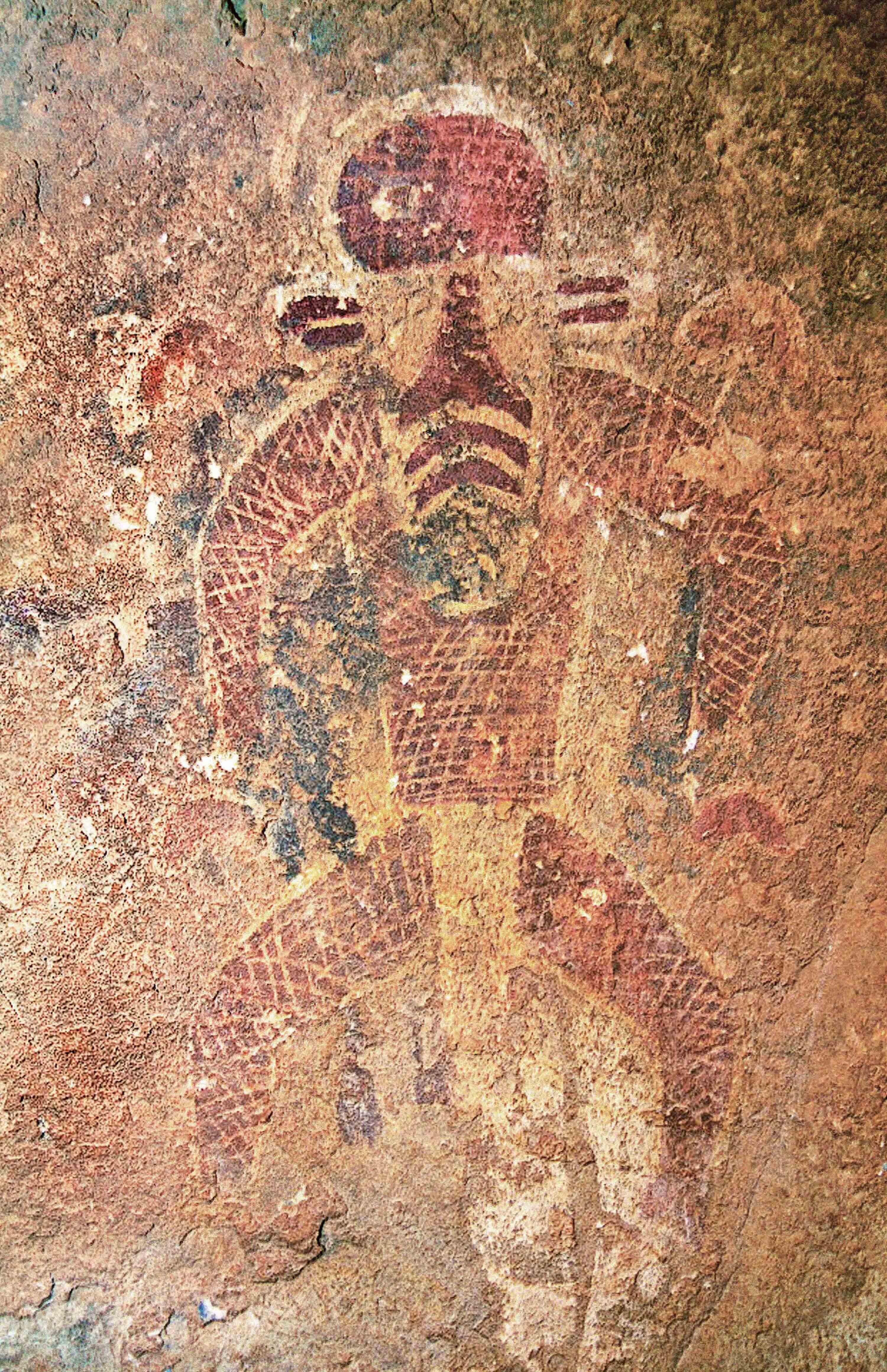 Rock painting of a masked figure.