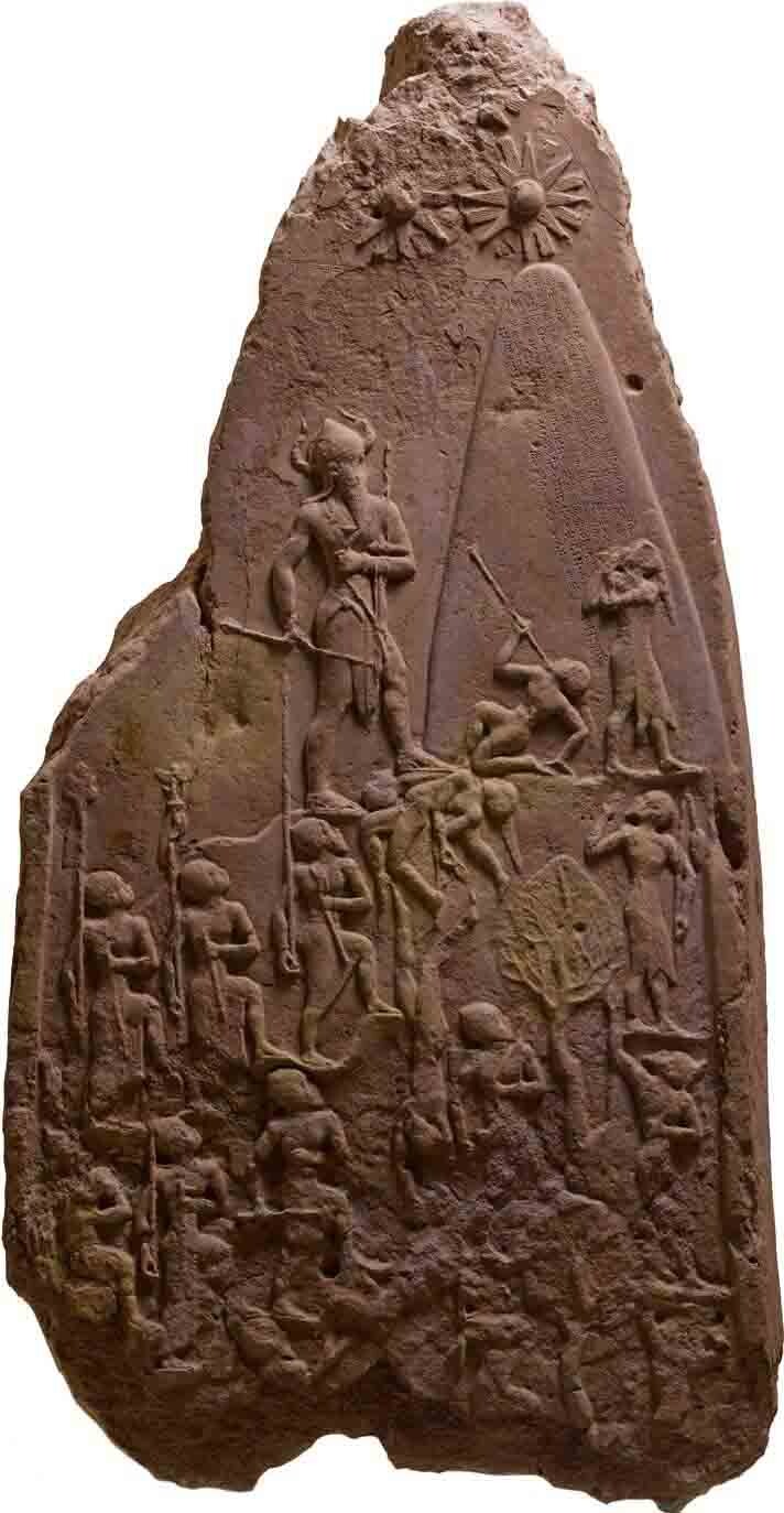 Tapered slab of purplish stone, with a carved relief.