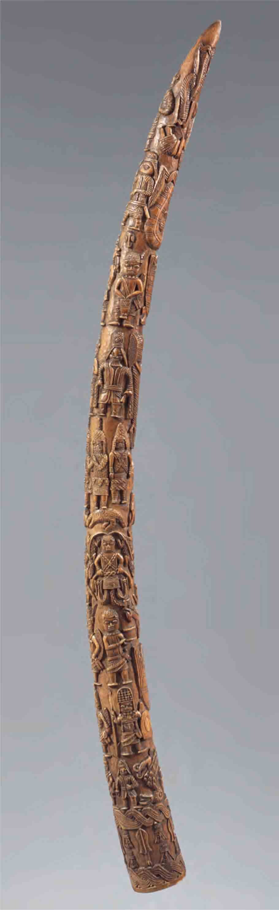 Carved ivory tusk, darkened with age.