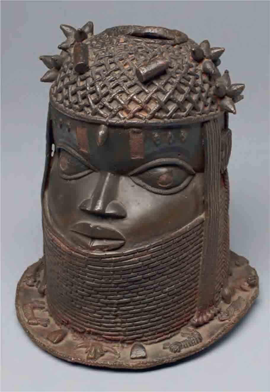 Sculpted head made of a copper-iron alloy, with a brown patina.