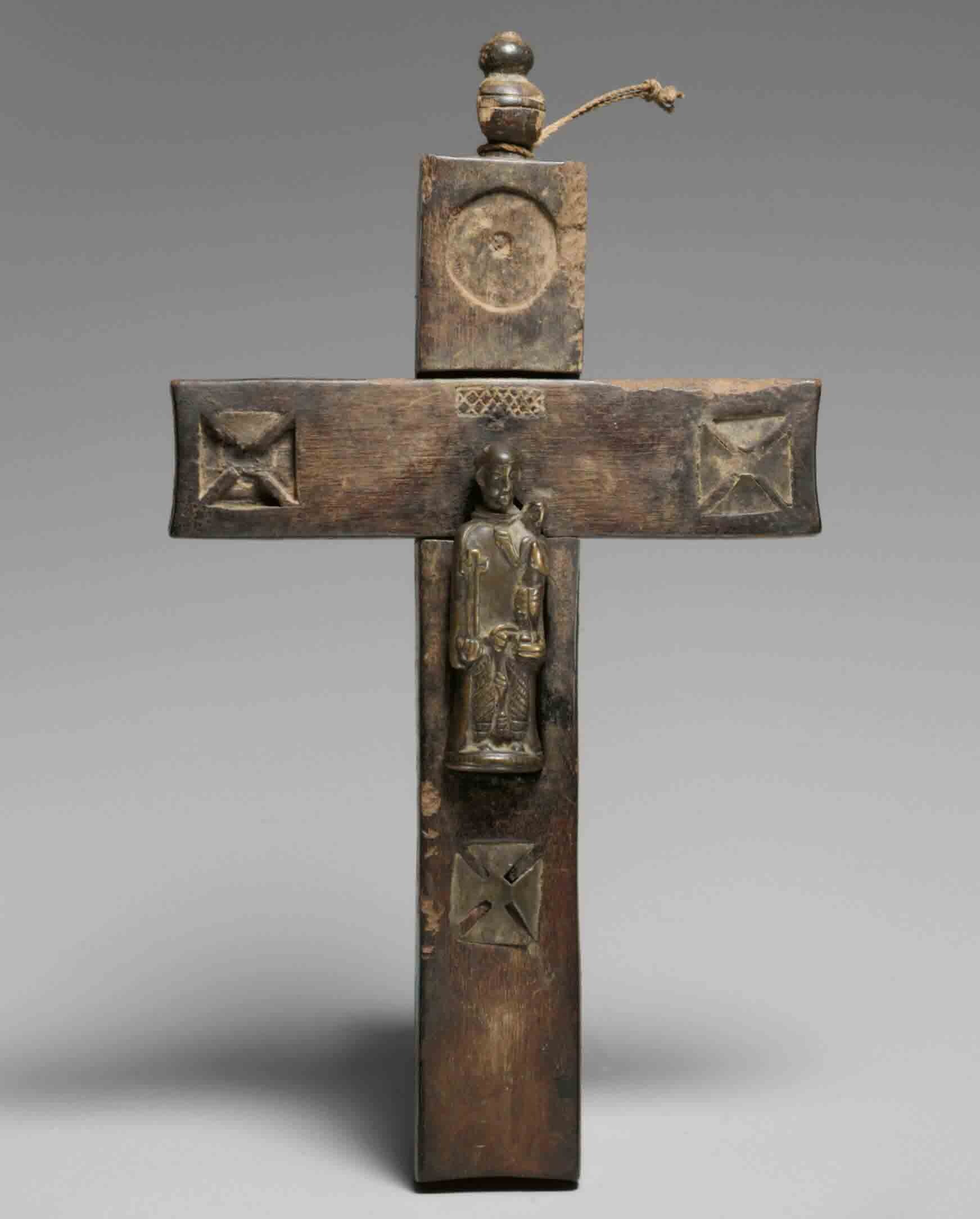 Wooden cross with small statue.