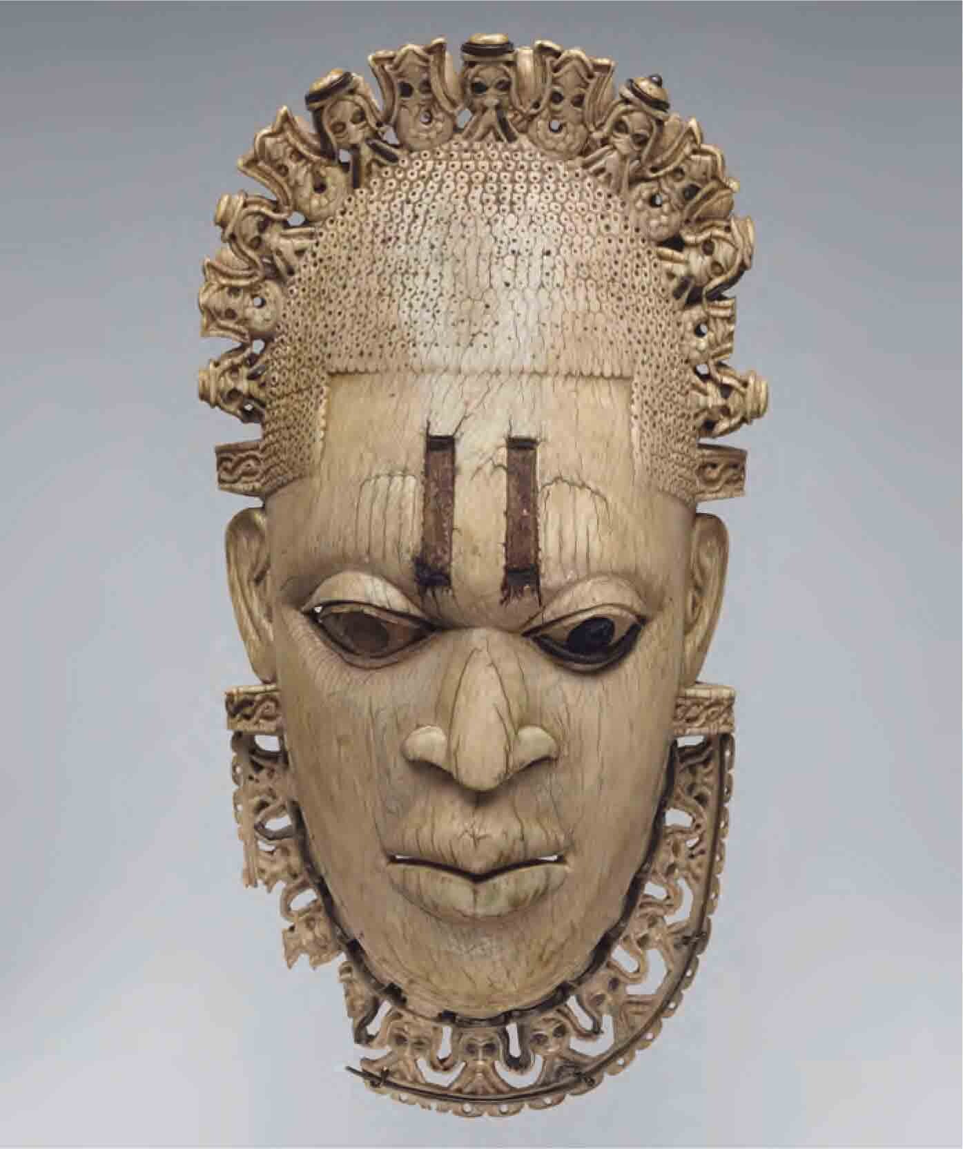 Pendant made of carved ivory, in the shape of a female human face. 