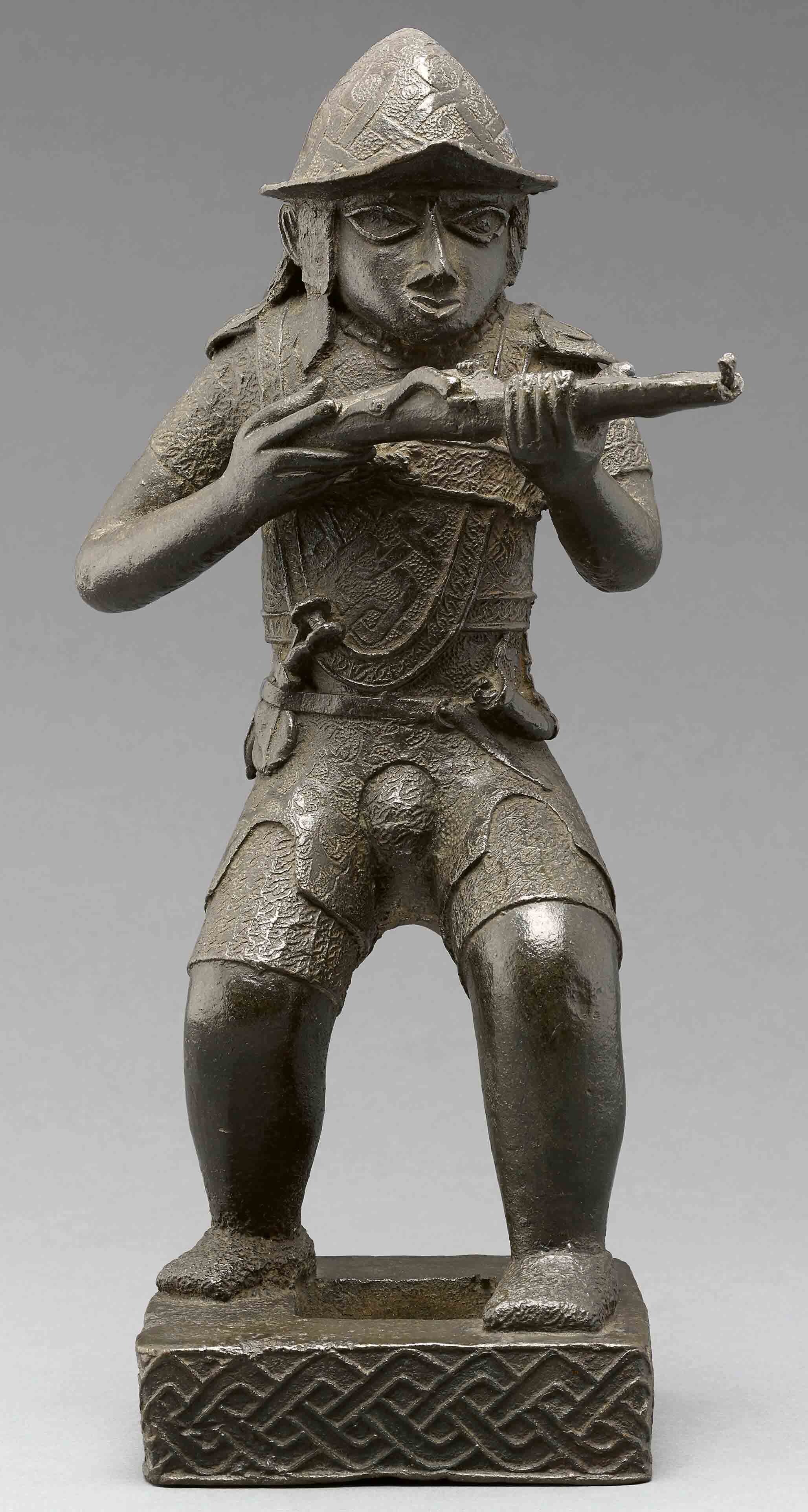 Statue of a European soldier, made of copper, with a dark-green patina.