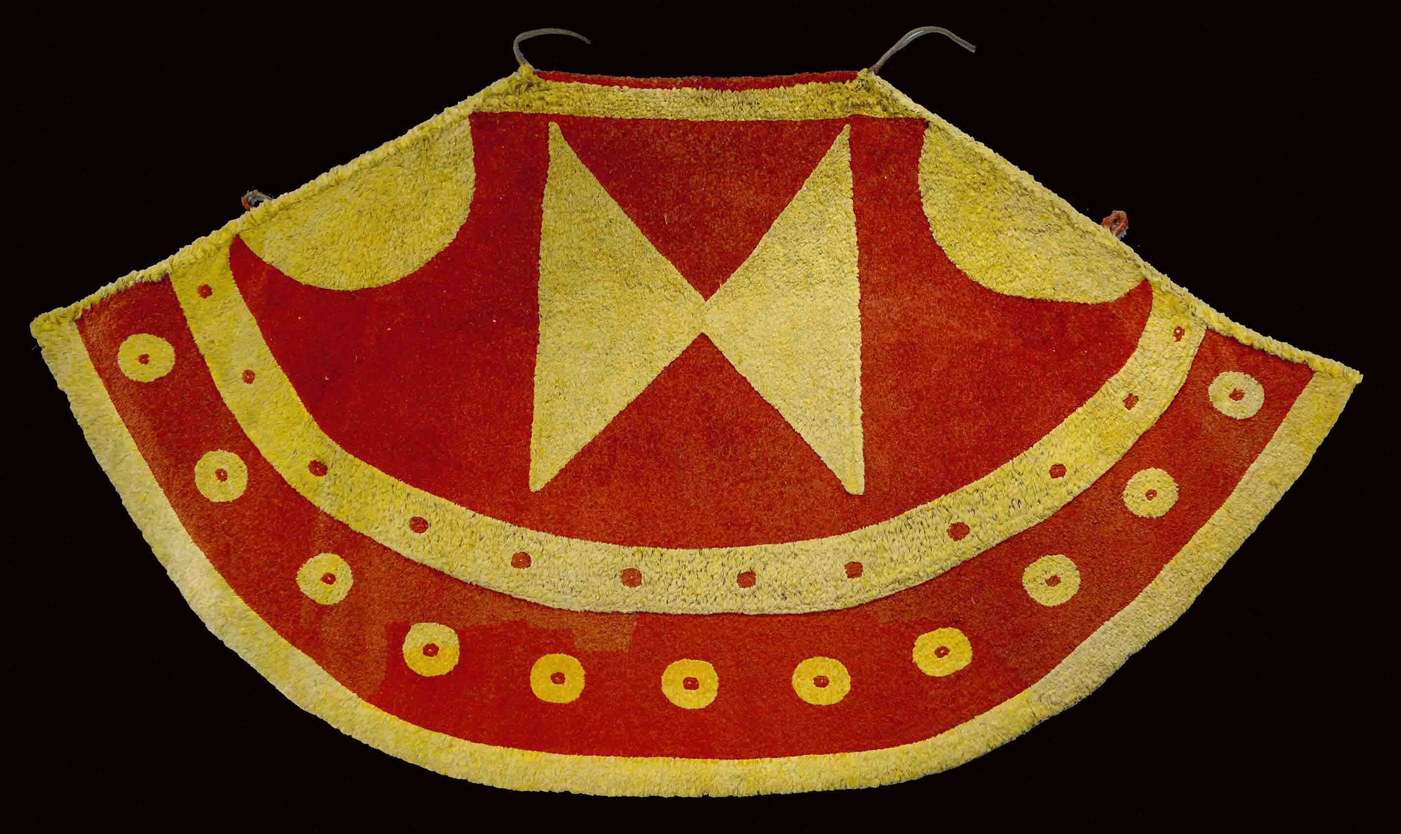 A red-and-white cloak made of feathers and fiber.