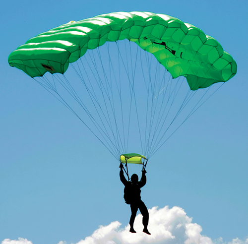 A photo shows a parachutist suspended from a flying parachute.