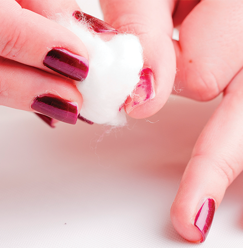 A photo shows nail paint being removed with a ball of cotton.