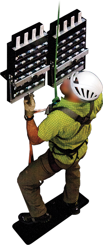 A photo shows a climber in a helmet and climbing harness, using adhesive pads to scale a surface.