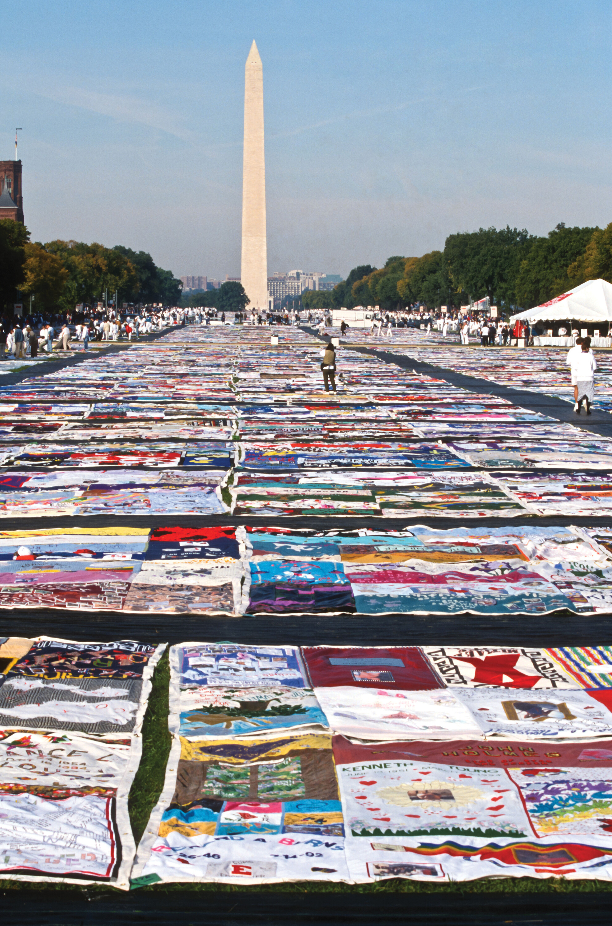 A photo of the A I D S memorial quilt spread across the Washington Monument lawn.