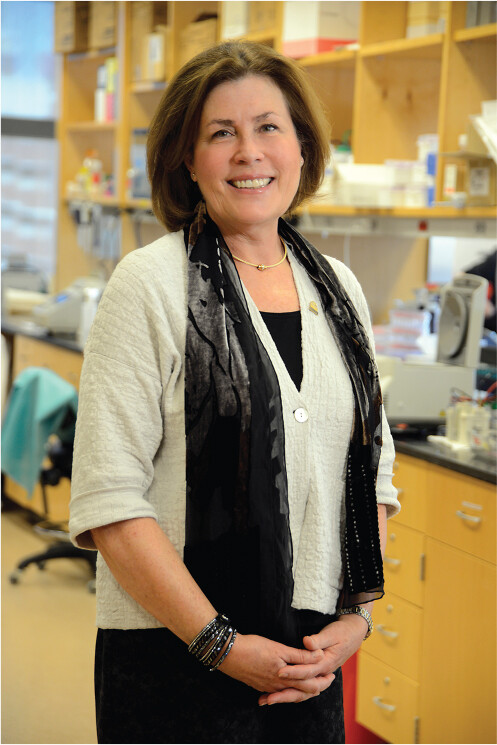 A photo of Claire Fraser standing in a laboratory.