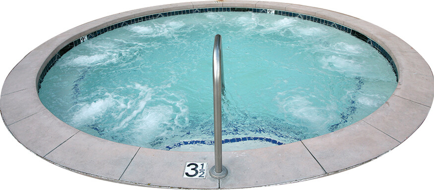 A photo of a circular in ground hot tub.
