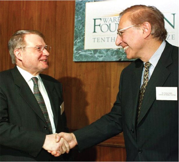 A photo of Luc Montagnier and Robert Gallo shaking hands.