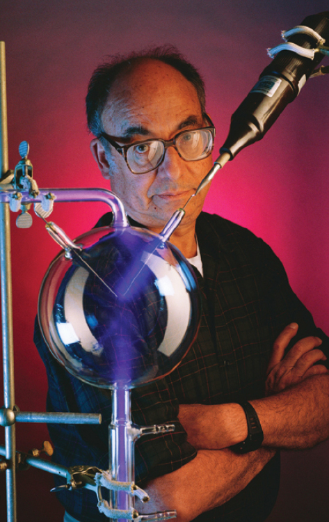 A photo of Stanley Miller and a photo of Juan Oro. A photo of Stanley Miller with the apparatus of his early-Earth simulation experiment.