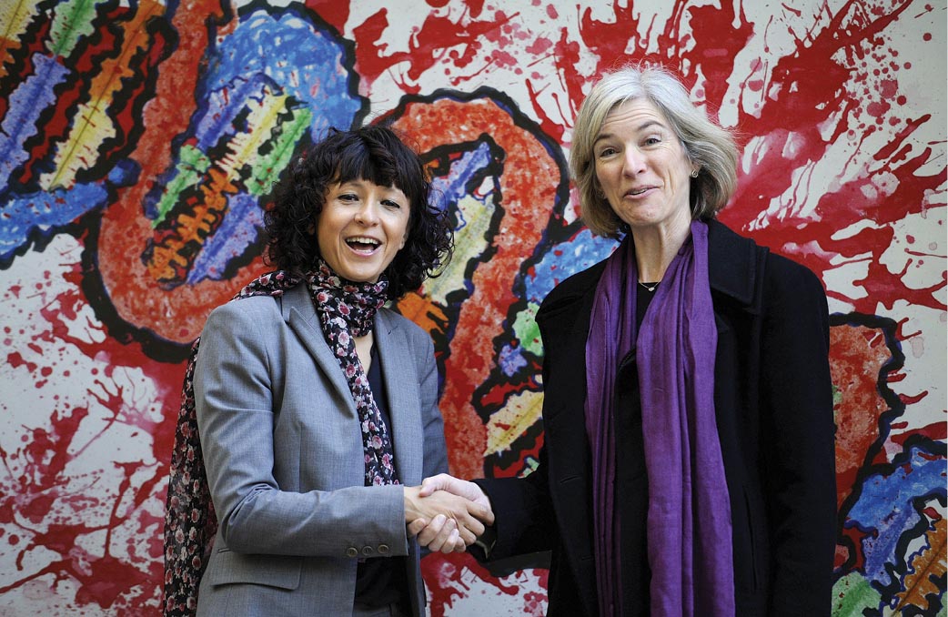 A photograph of Emmanuelle Charpentier and Jennifer Doudna shaking hands.