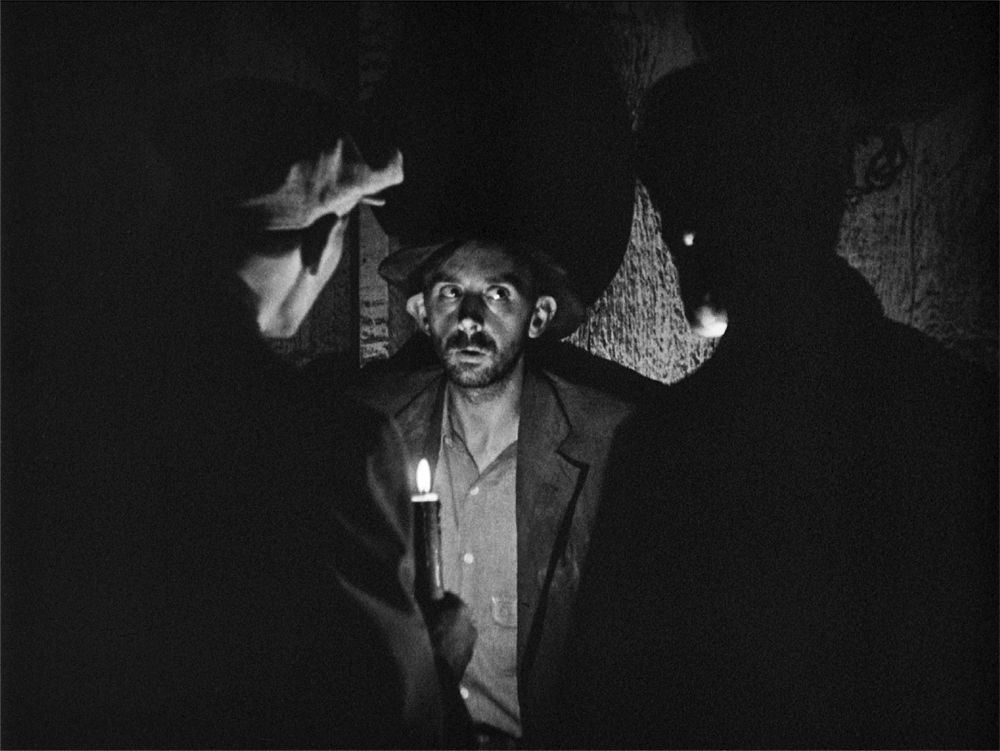 In The Grapes of Wrath three men are gathered around a candle light.