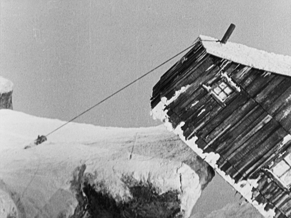A taught rope keeps the cabin from falling off the cliff in The Gold Rush.