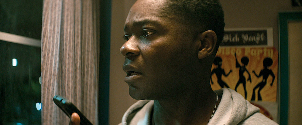 A detective gazes worriedly out a dark window as he receives a call from his recently murdered niece in Don’t Let Go.
