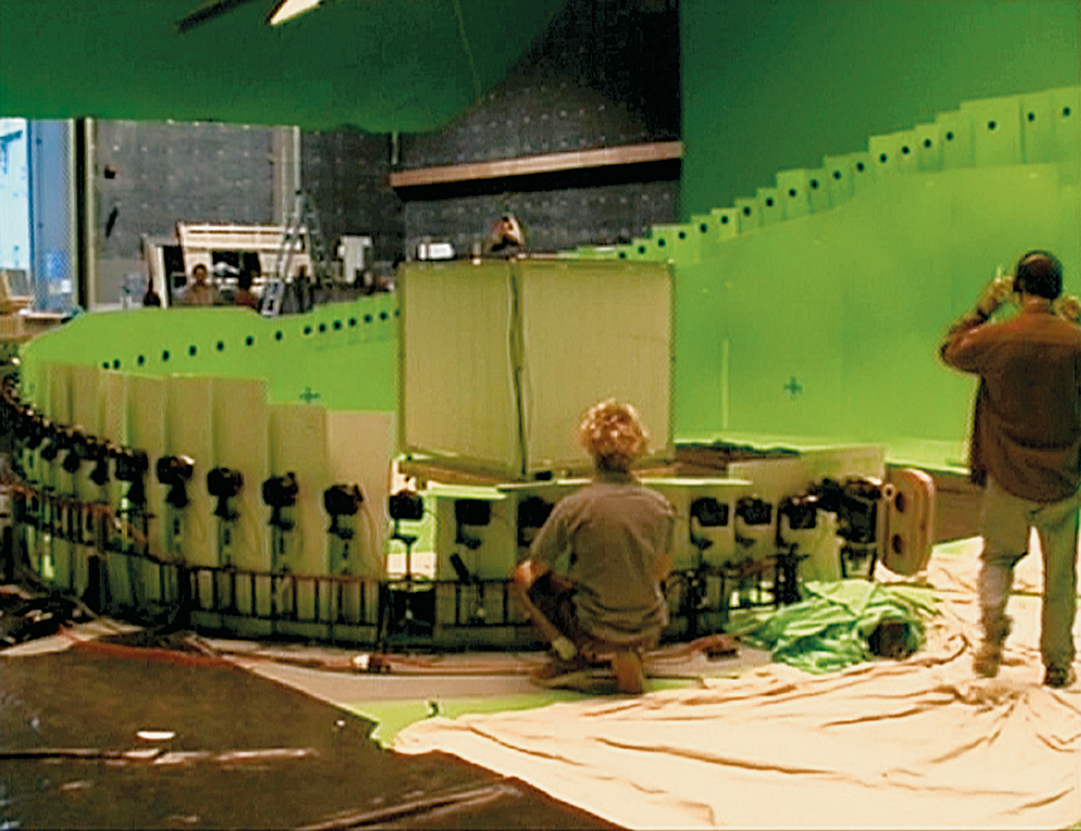 A production crew films on a circular set with 120 individual cameras that are able to shoot the action as it occurs in The Matrix.