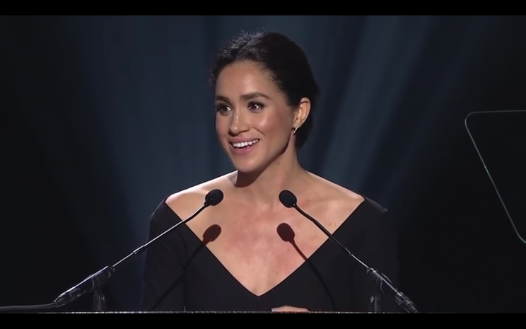 Megan Markle smiles as she addresses her audience.