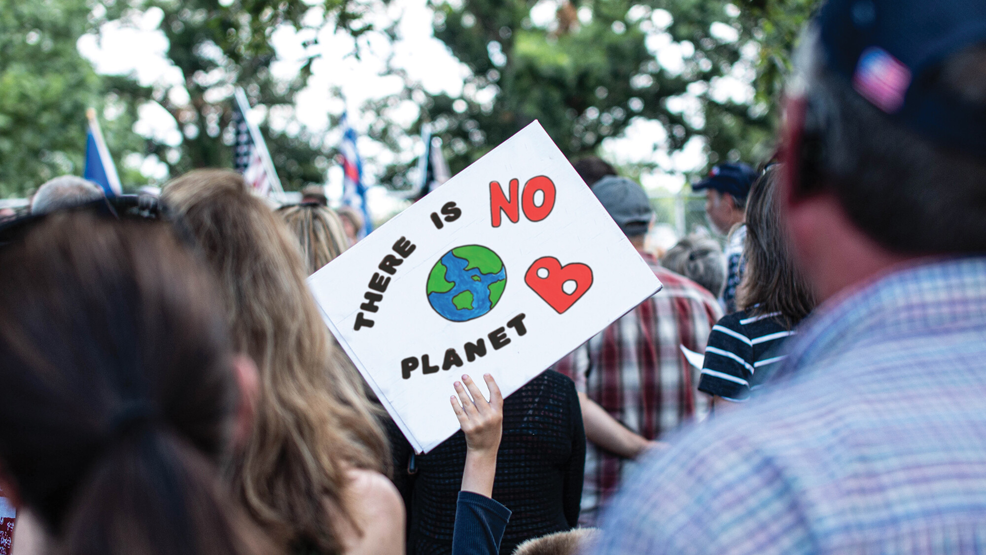 A group of people outdoors at an environmental rally.