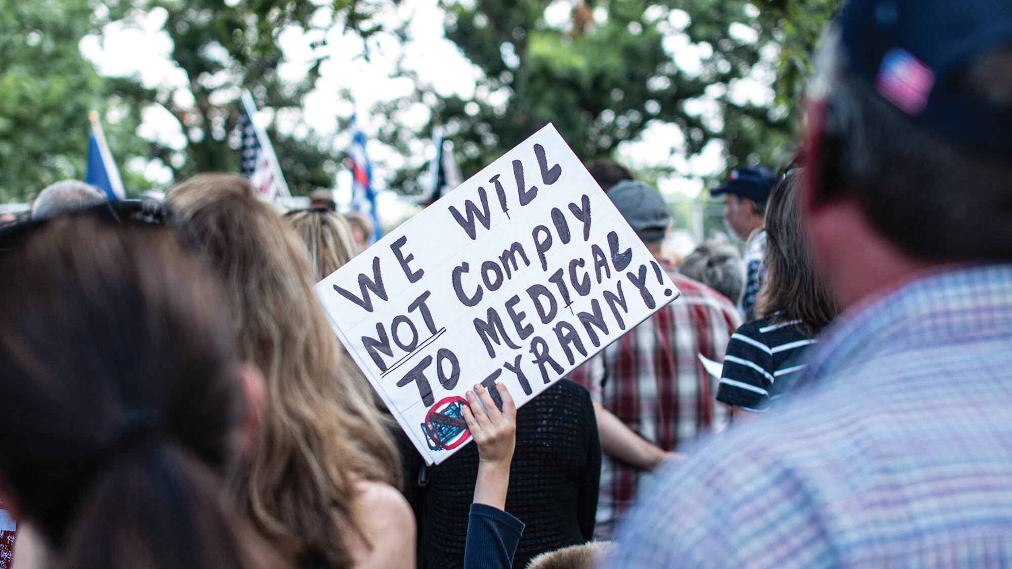 A group of people outdoors at a political rally.