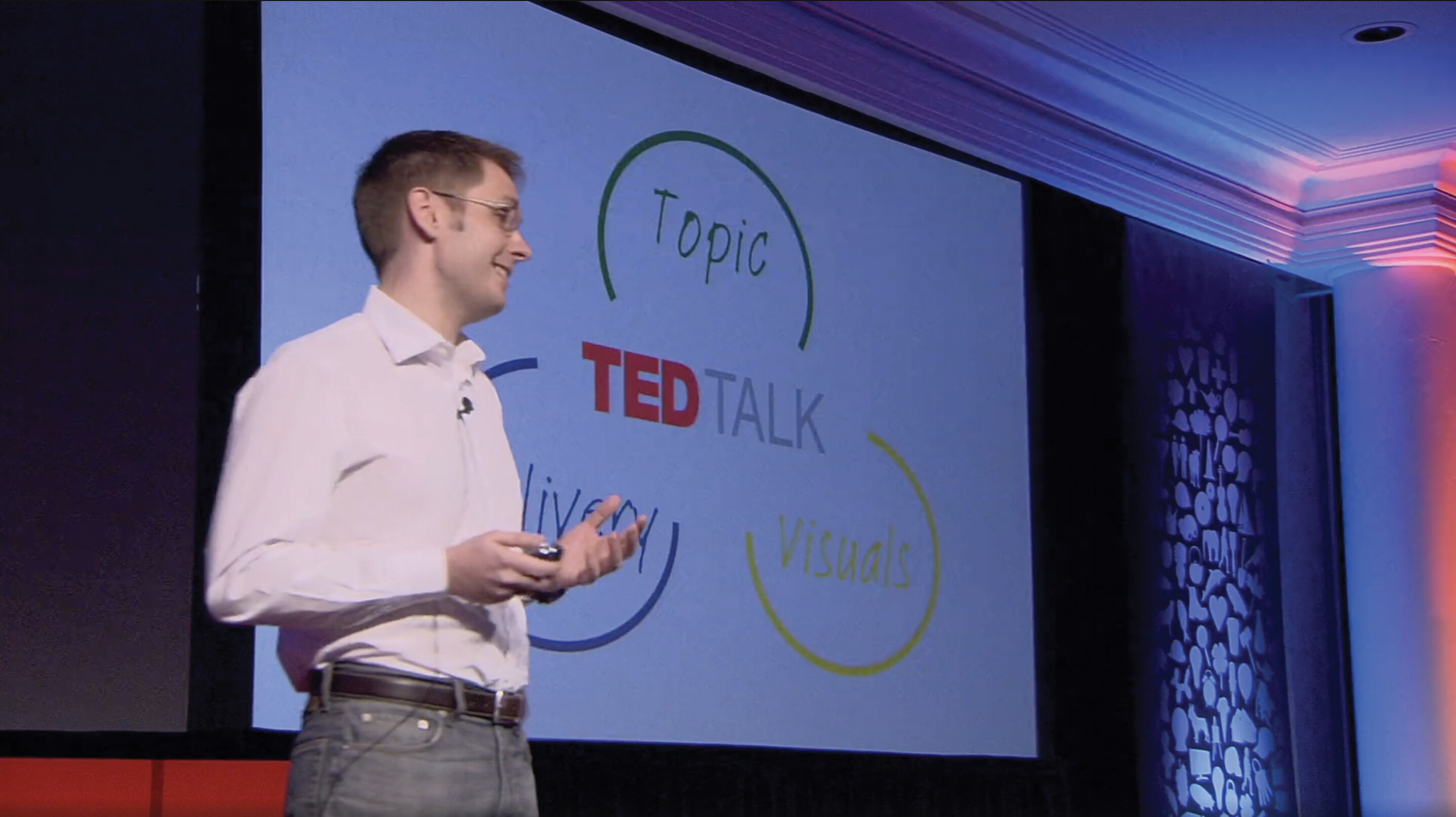 A screenshot of Sebastian Wernicke’s TED talk. He stands on a stage in an auditorium.