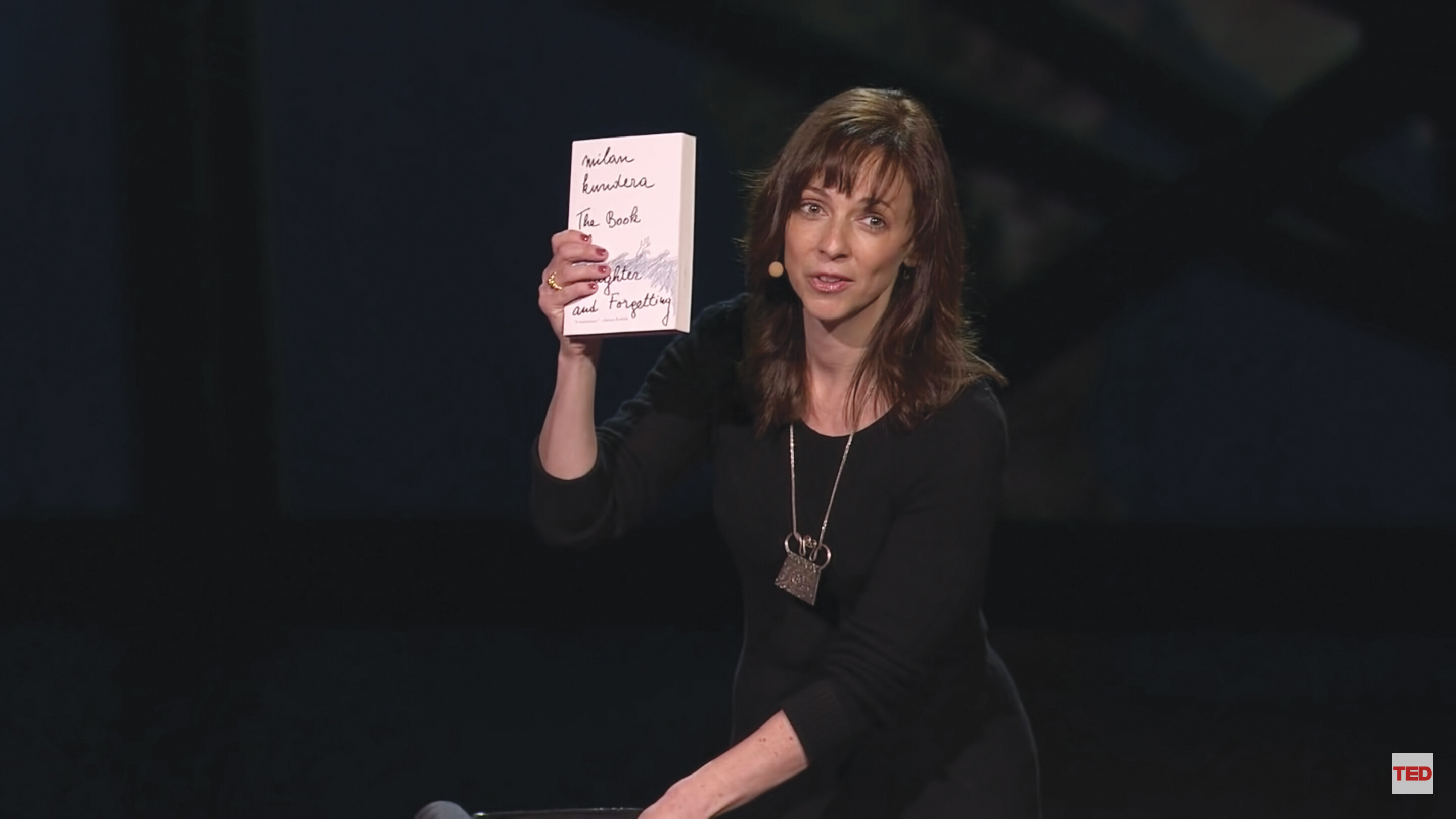 A screenshot of Susan Cain’s TED talk. She stands on a stage in an auditorium.