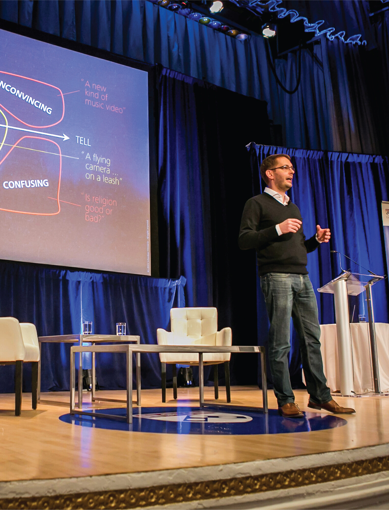 Sebastian Wernicke speaking on stage in front of a screen with a presentation.