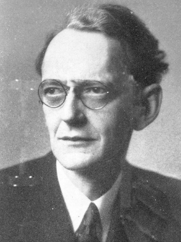 A man wearing glasses, and a suit and tie.