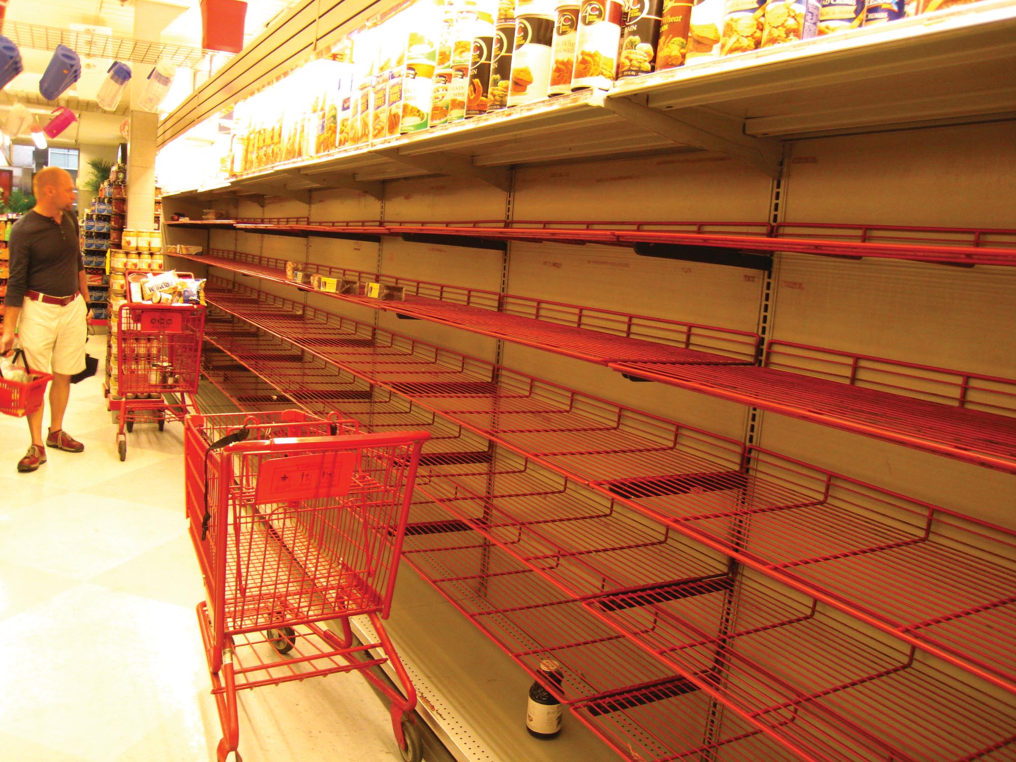 Empty shelves in the bread aisle of a supermarket.