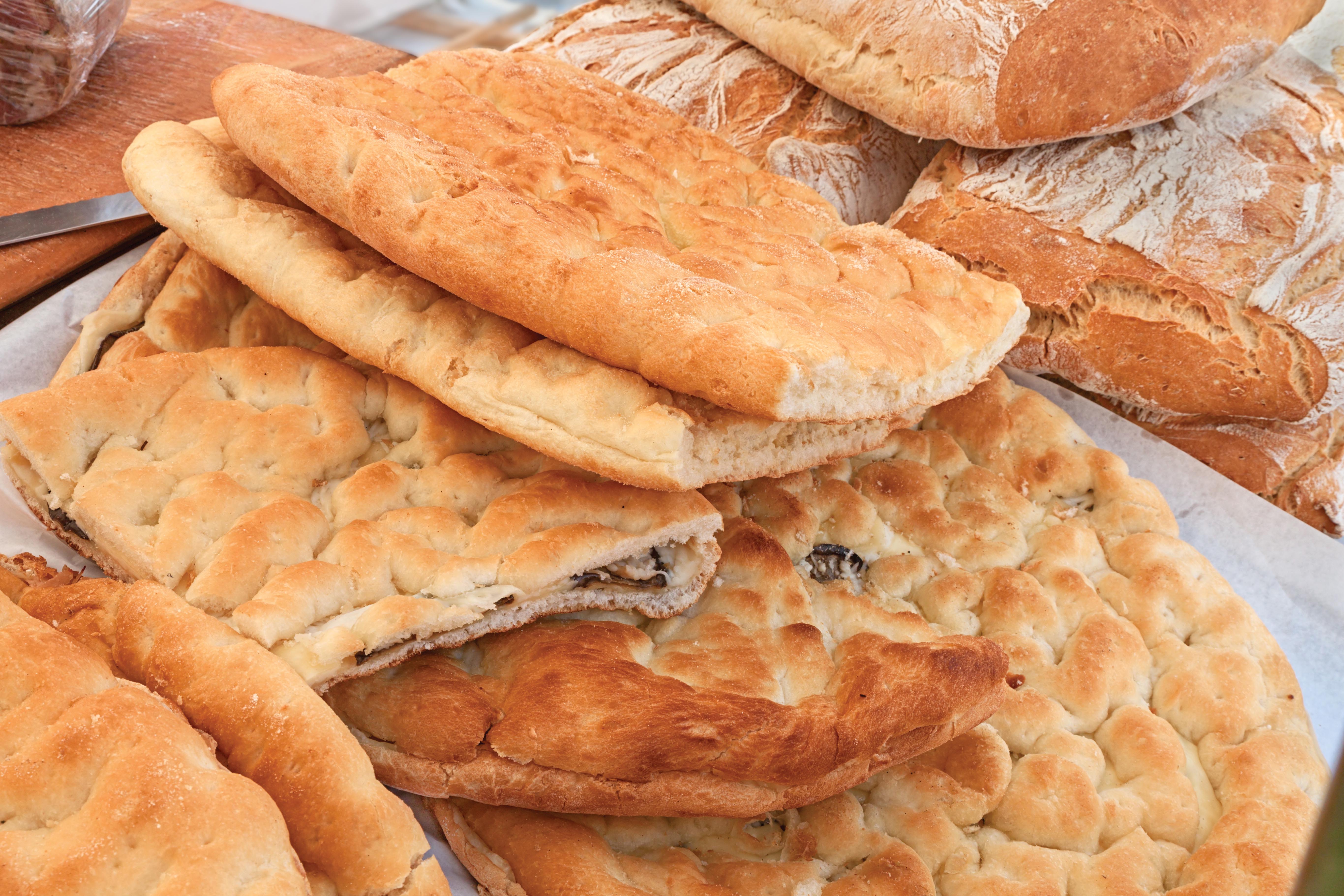 Pieces of focaccia bread on a tray.