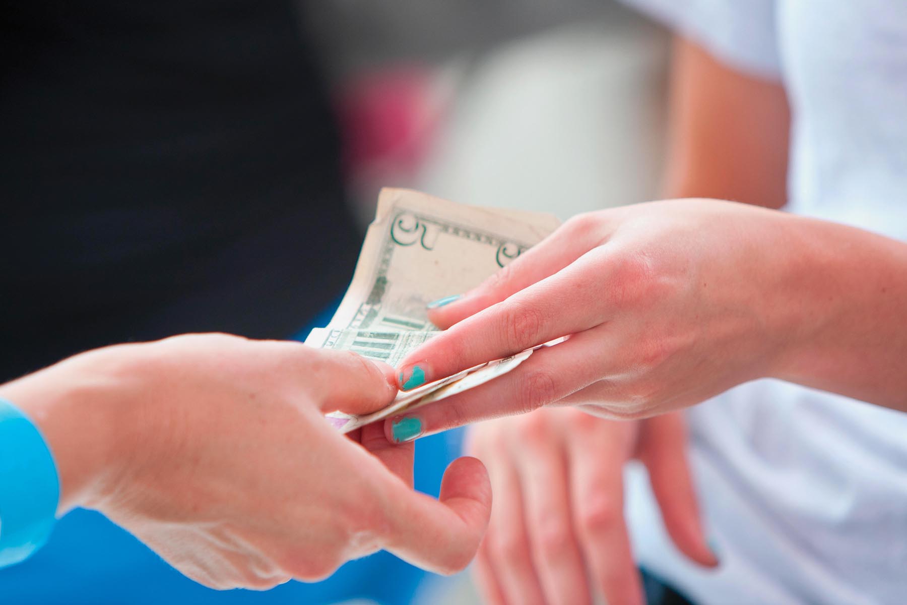 Paper money changing hands.