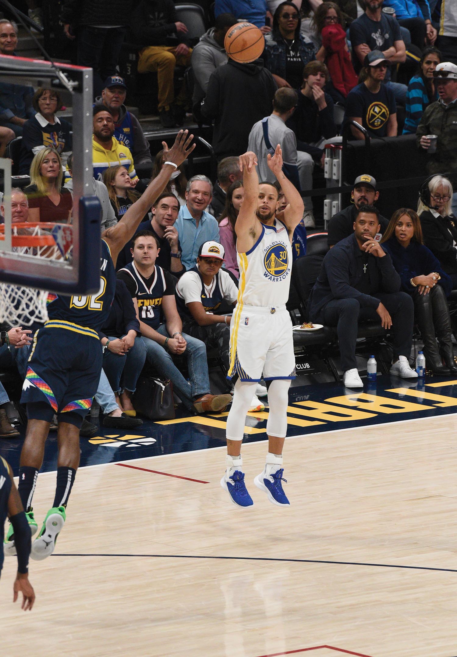 Basketball player Steph Curry smiling and pointing at someone.