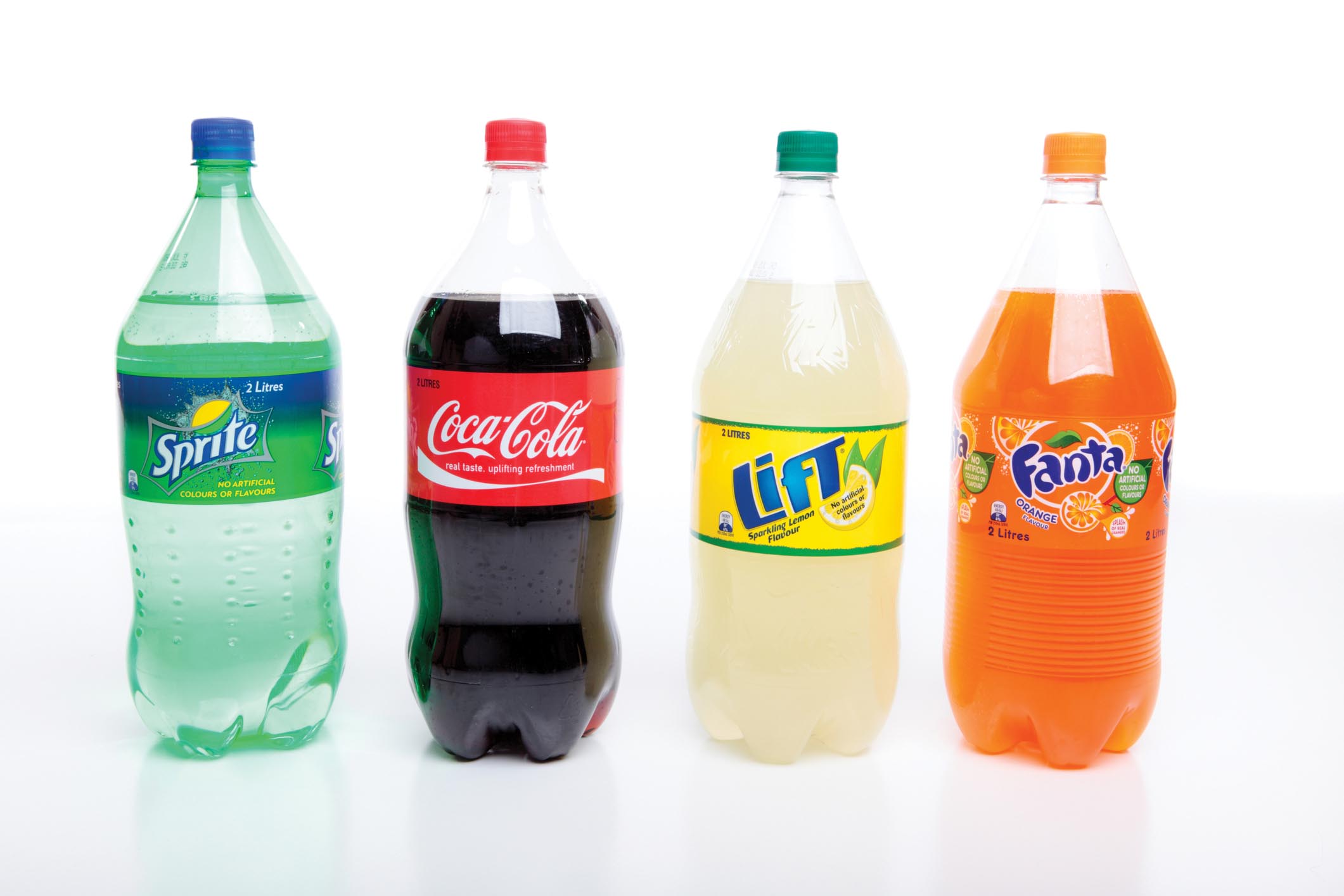 Four different brands of two-liter sodas: Sprite, Coca-Cola, Lift, and Fanta.