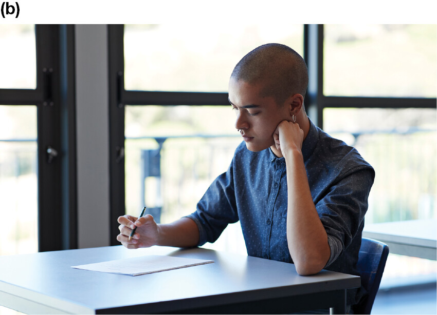 A man sitting at a desk and attempting a test.