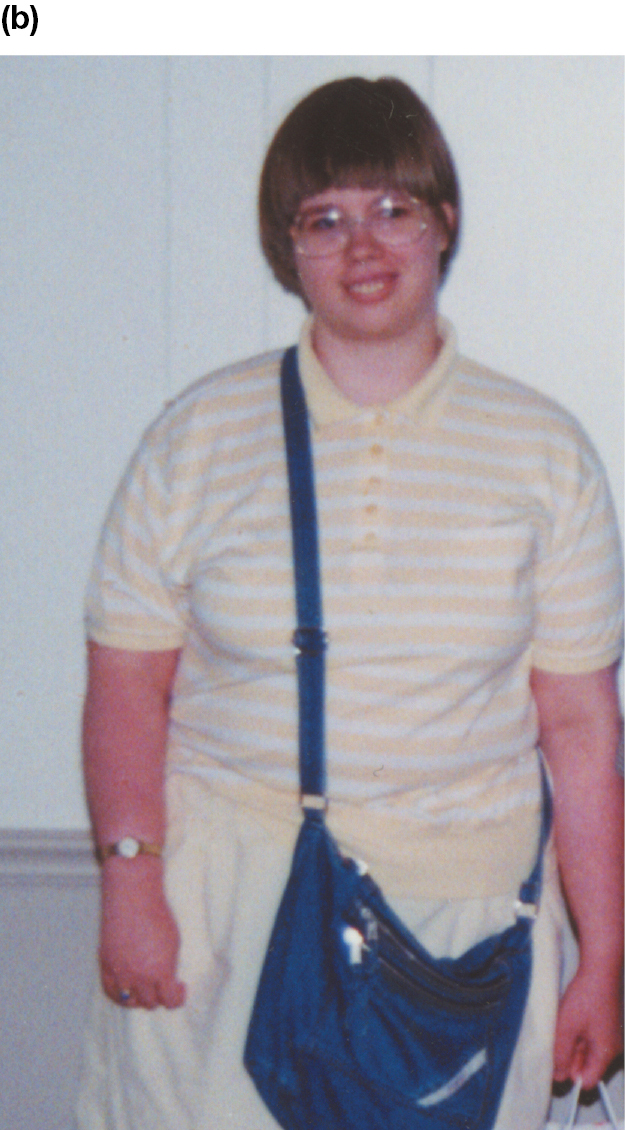 A photo of a smiling young woman in a loose-fitting shirt and pants. She has large glasses on and a purse.