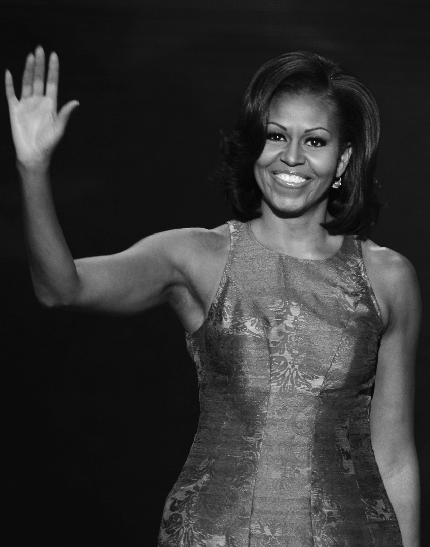 A photo of Michelle Obama waving.