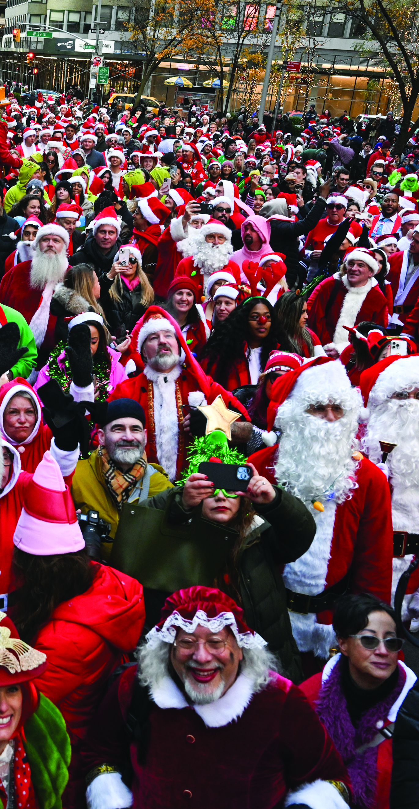 A photo shows a city street filled with people dressed as santa or in other festive clothing.
